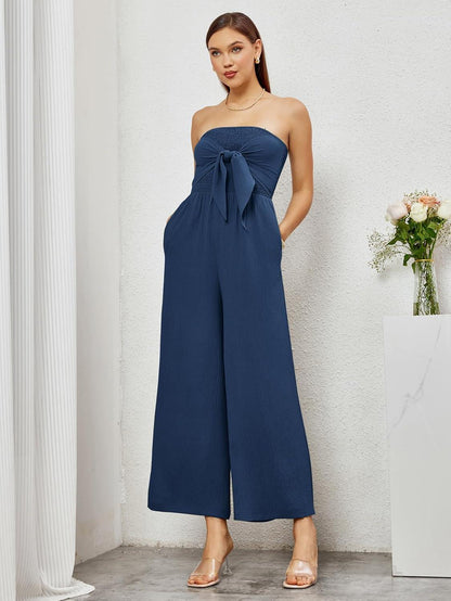 Strapless marineblauwe jumpsuit met wijde pijpen en strik